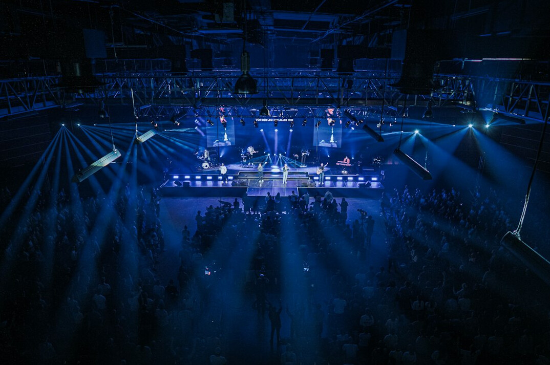 Large stage with lighting and audience seating before a live event