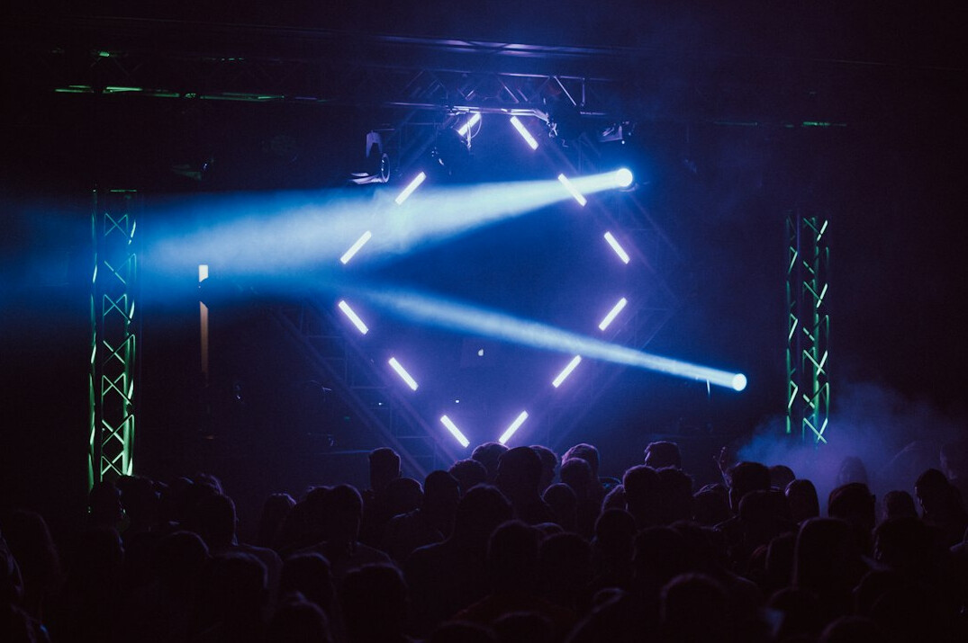 Stage lighting rig with bright spotlights over a stage