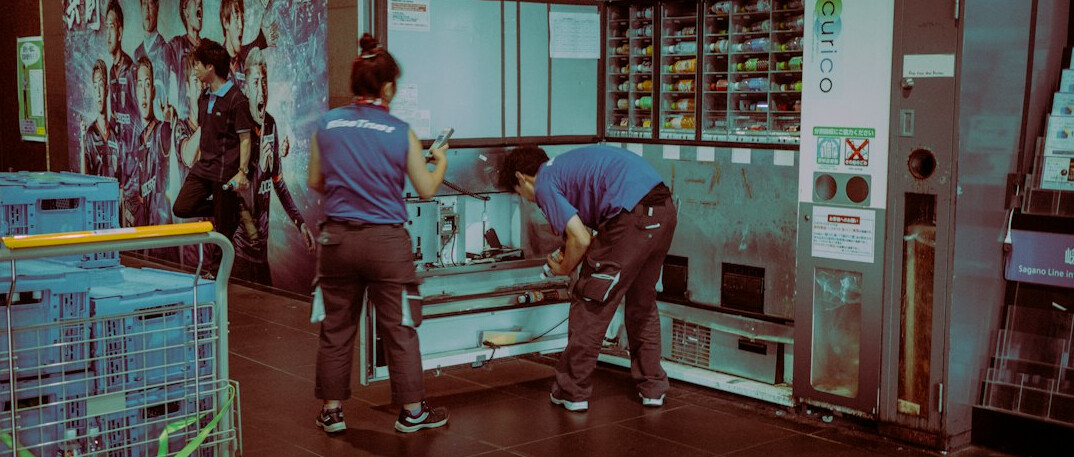Engineers working with equipment and laptops in a technical space